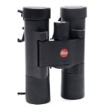 A pair of Leica 'Ultravid' compact binoculars in black travel bag:.