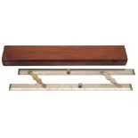A polished steel parallel rule in mahogany case:, of traditional form with moustache hinges,
