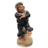 A Continental bisque porcelain humorous figure of a sailor: modelled barefoot in uniform and