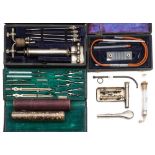 A silver plated syringe by Evans & Sons , London in a fitted case with needles,