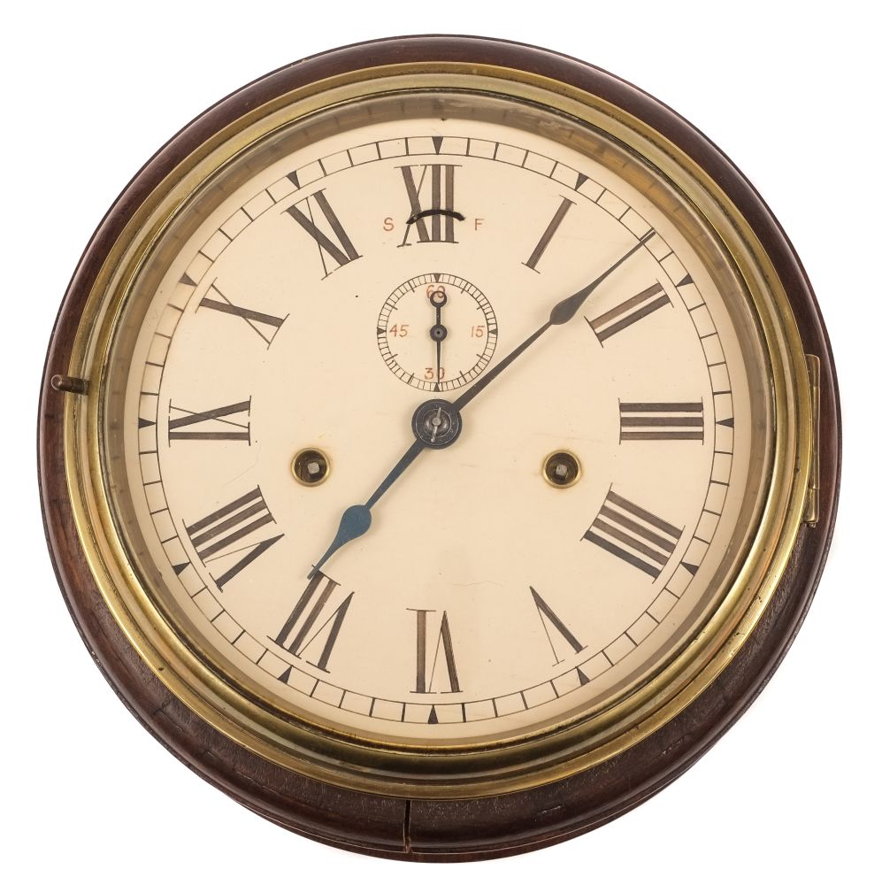 A brass bulkhead clock in an oak mount:, unsigned,