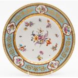 A Vienna porcelain plate: painted with scattered floral sprays and sprigs within a gilded pale blue