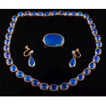 An early 20th century gold and lapis lazuli necklace: with graduated oval stones in Roman setting,
