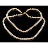 A graduated cultured pearl two-string necklace: with cultured pearls graduated from 7mm to 7.