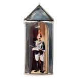 A sterling silver and enamel novelty vesta case: in the form of a sentry box with dismounted