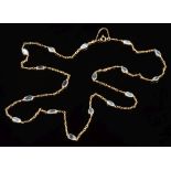 A gold and moonstone necklace: with seventeen oval moonstones each approximately 10mm long and in