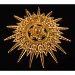 A gold star burst faceted and pierced pendant/brooch: 61mm diameter, 27.5gms gross weight.