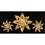 An 18ct gold and diamond mounted flower head brooch and matching ear-clips: each with a circular