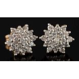 A pair of 18ct gold and diamond mounted circular cluster earrings: with clusters of small circular