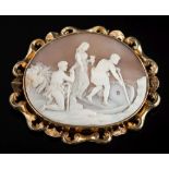 A large oval shell cameo brooch: the cameo depicting three classical figures boarding a small boat,