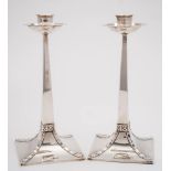 A pair of George V Arts and Crafts influence candlesticks, maker George Edwards & David Edwards,