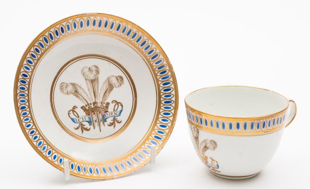 A Caughley 'Prince of Wales' plume cup and saucer: finely painted in blue,