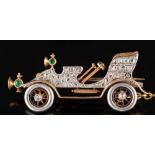 An Art Deco rose diamond and emerald-set vintage 'De Dion' style motor car brooch: pave-set with