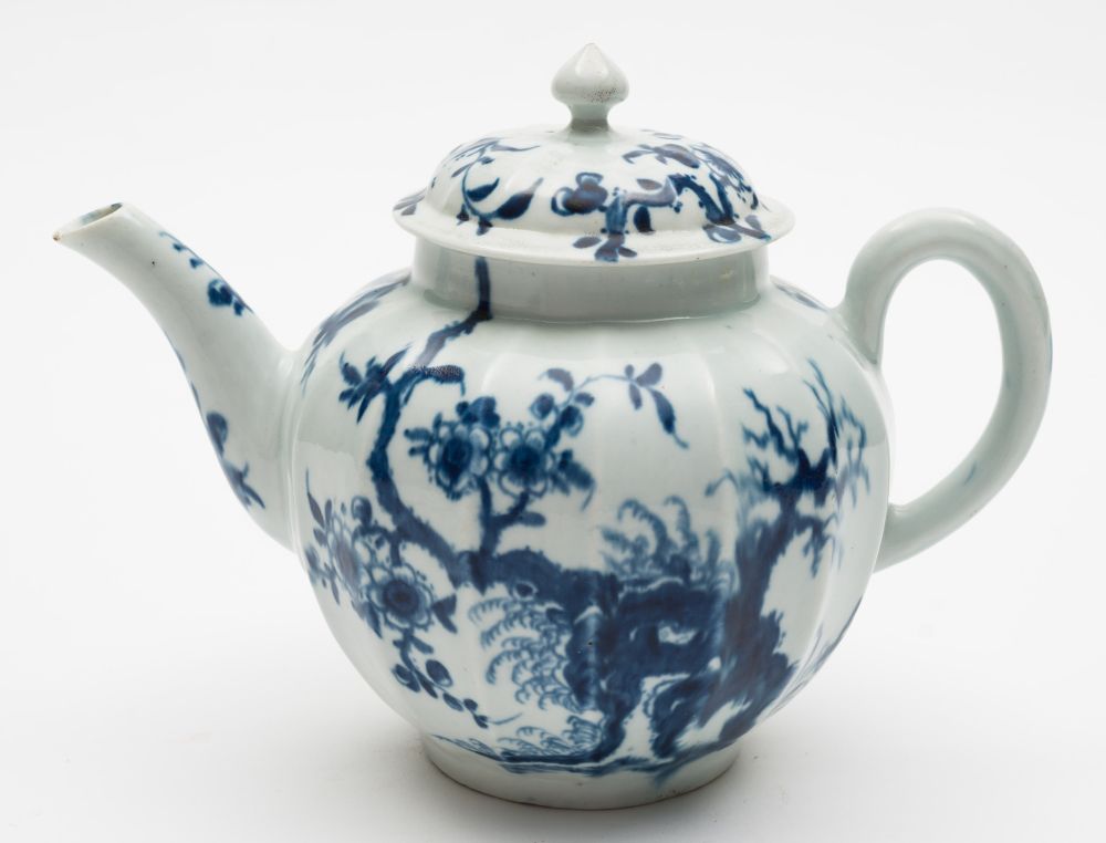 A First Period Worcester porcelain teapot: of fluted form painted in blue in the Prunus Root