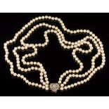 A cultured pearl three-string necklace: with a diamond mounted heart-shaped clasp, 14.