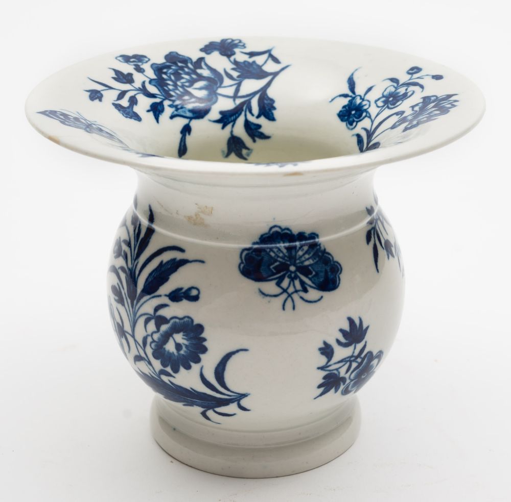 A First Period Worcester porcelain spittoon: printed in blue in the Three Flowers pattern,