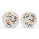 A pair of Chelsea fluted saucers: painted in bright famille rose colours with a long-tailed bird