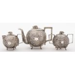 An Indian silver three-piece tea service: of circular form with all over foliate decoration with