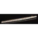 An early 20th century platinum-faced gold and diamond mounted line bar brooch: of tapering form,