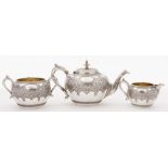 A Victorian Scottish silver three-piece tea service, maker JR, Glasgow, 1876: initialled,