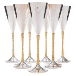 Seven Elizabeth II silver and gilt champagne flutes, maker Stuart Devlin, London, 1977, 1978,