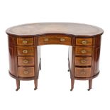 An Edwardian mahogany, satinwood crossbanded and inlaid kneehole desk:, of kidney shaped outline,