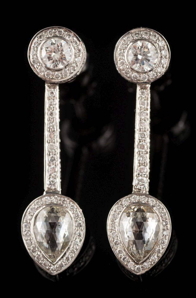 A pair of 18ct white gold and diamond pendant earrings: each with a pear-shaped briolette-cut