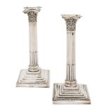 A matched pair of Edward VII silver Corinthian column candlesticks, maker Walter Latham & Sons,