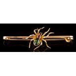 A 15ct gold, green gem and ruby-set 'spider' bar brooch:, 62mm total length, 7gms gross weight.