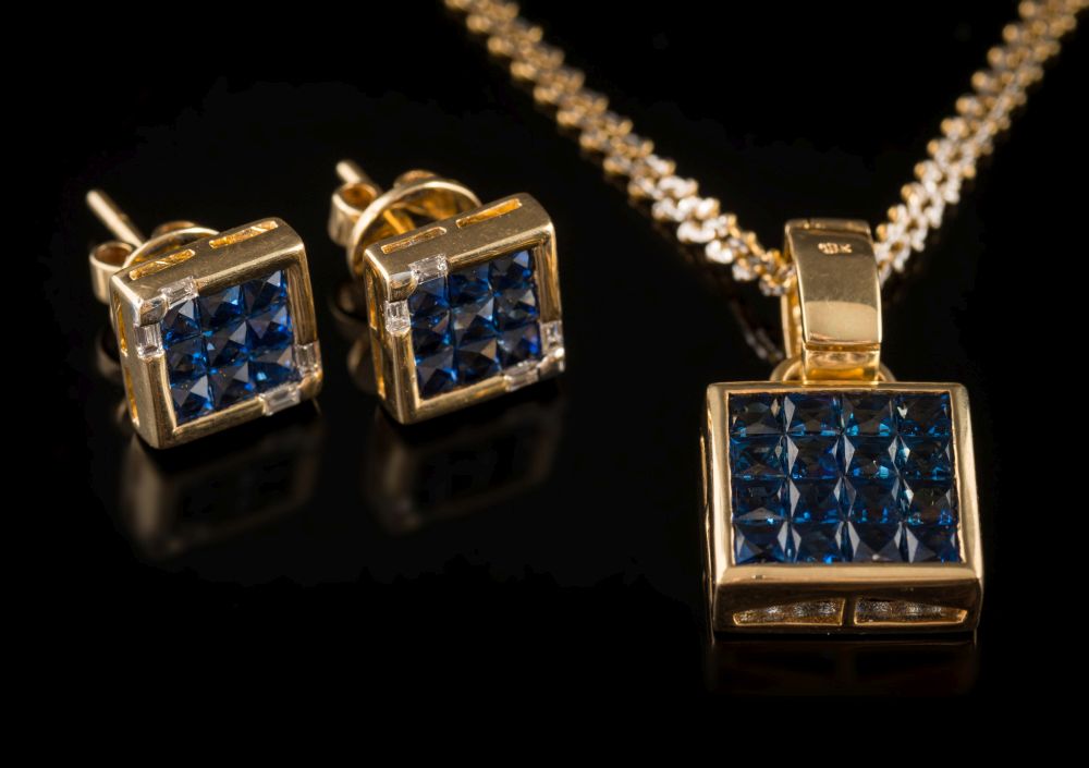 A square-cut sapphire sixteen-stone pendant: the square pendant approximately 2.