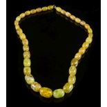 A graduated amber bead single-string necklace: with thirty three oblong beads graduated from 16mm