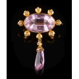 A gold, pink topaz and diamond brooch: the oval pink topaz 11.8mm wide x 18.