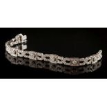 A diamond mounted Art Deco-style bracelet: of square and lozenge-shaped linking,