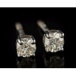 A pair of 9ct white gold and diamond single-stone ear studs: each with a circular,