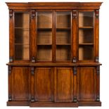 A Victorian mahogany breakfront library bookcase:, the upper part with a moulded cornice,