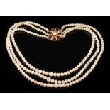 A cultured pearl three-strand necklace: the cultured pearls graduated from 4mm diameter to 7mm