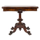 A Victorian carved walnut card table:, of serpentine outline,