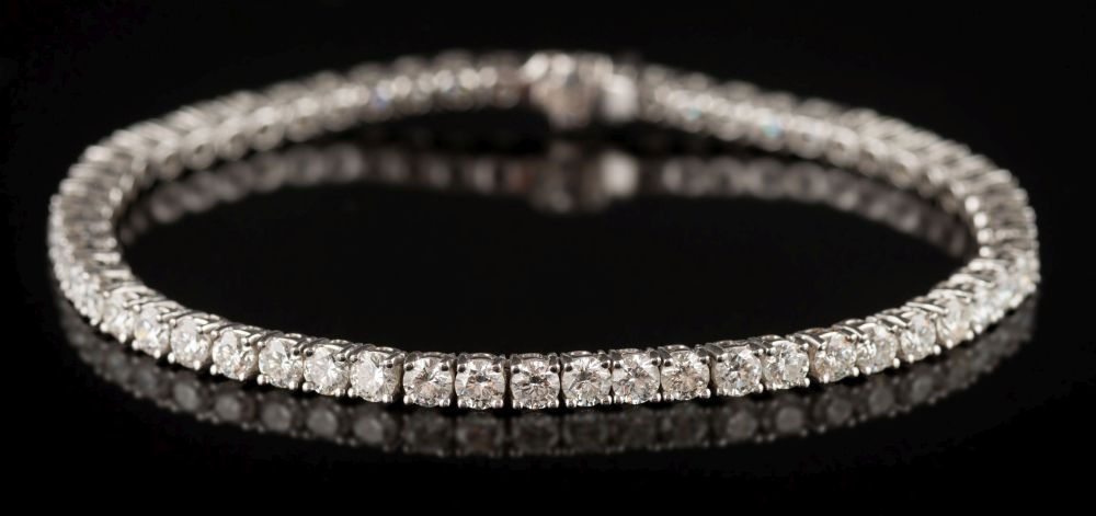 An 18ct white gold and diamond-set line bracelet: with fifty-seven circular brilliant-cut diamonds