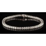 An 18ct white gold and diamond-set line bracelet: with fifty-seven circular brilliant-cut diamonds