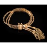 A three-strand bracelet of rectangular tube-like linking:, each strand with tassel terminal,