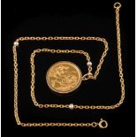 A sovereign dated '1958' within a 9ct gold mounted pendant frame:, on an 18ct gold,