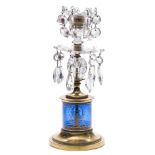 A Regency cut-glass and brass candlestick: the blue glass column gilded with classical figures