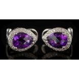 A pair of faceted pear-shaped amethyst and diamond surround ear clip/studs: each faceted amethyst