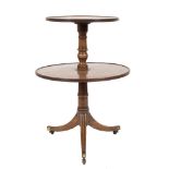 A Regency mahogany circular two tier graduated dumb waiter:, the revolving tops with reeded edges,