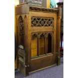 A pair of late Victorian oak pew frontals:, with sloping tops,