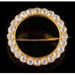 A gold and diamond surround circular brooch: with twenty four round old brilliant-cut diamonds