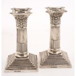 A pair of George V silver Corinthian column desk candlesticks, maker Harrison Brothers and Howson,