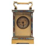 An Edwardian French brass and enamelled carriage clock: the eight-day duration timepiece movement