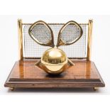An early 20th century brass and oak tennis inkstand:, 17cm wide.