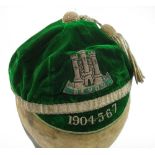 A Devon Country Rugby cap 1904-5-6-7:, green velvet with silvered tassel an band.